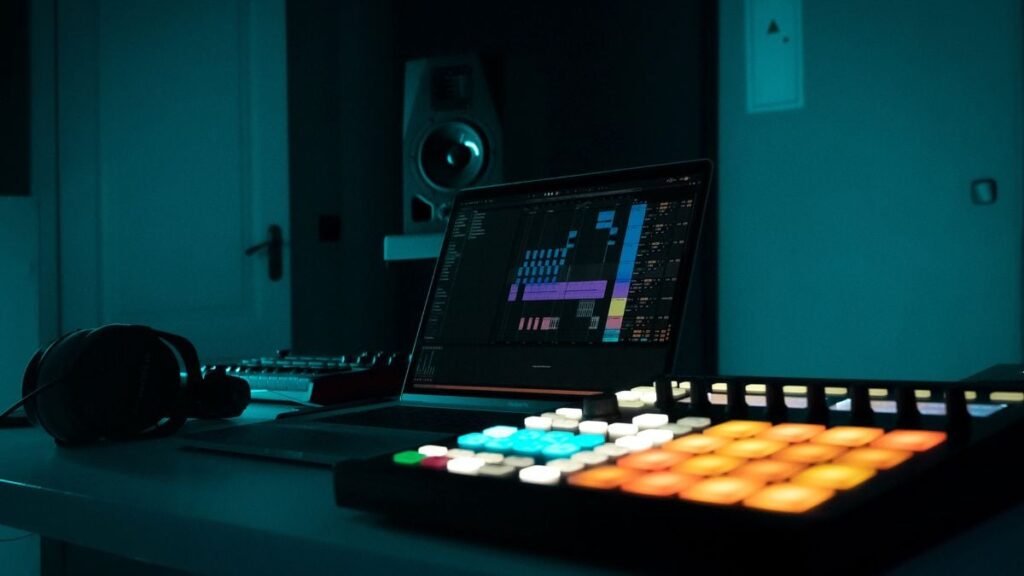 Ableton Live 12 trap beat course — laptop with Ableton and a pad controller in a studio